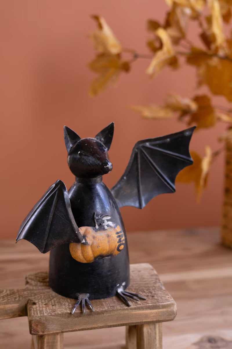 Recycled Metal Bat Holding a Pumpkin
