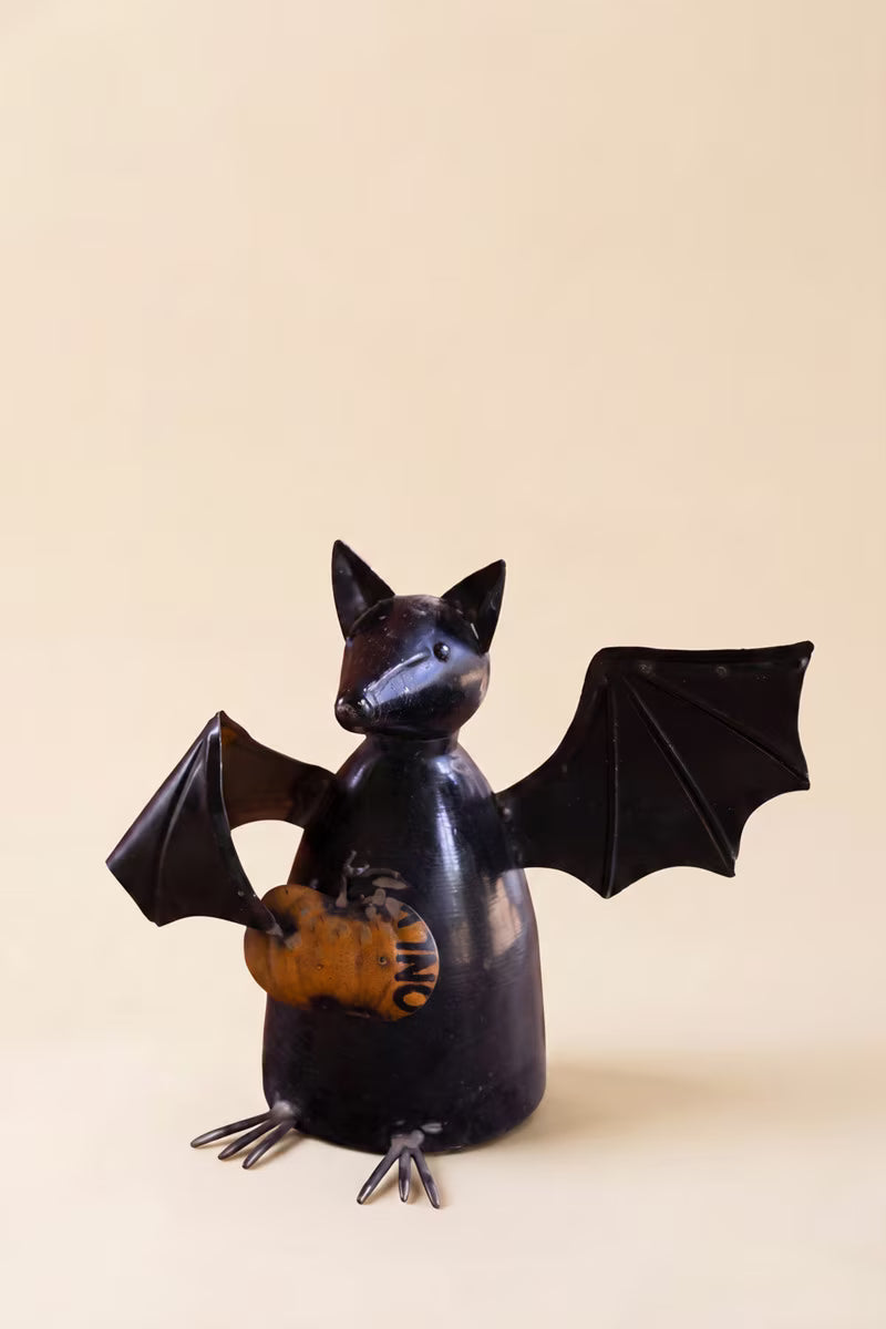 Recycled Metal Bat Holding a Pumpkin