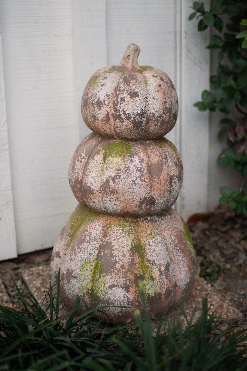 three stacked faux concrete pumpkins