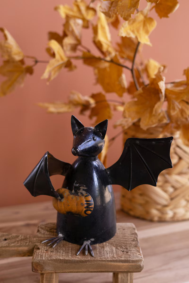 Recycled Metal Bat Holding a Pumpkin
